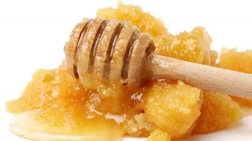 Honeycomb with dripping honey and a wooden dipper-16-9-rectangle